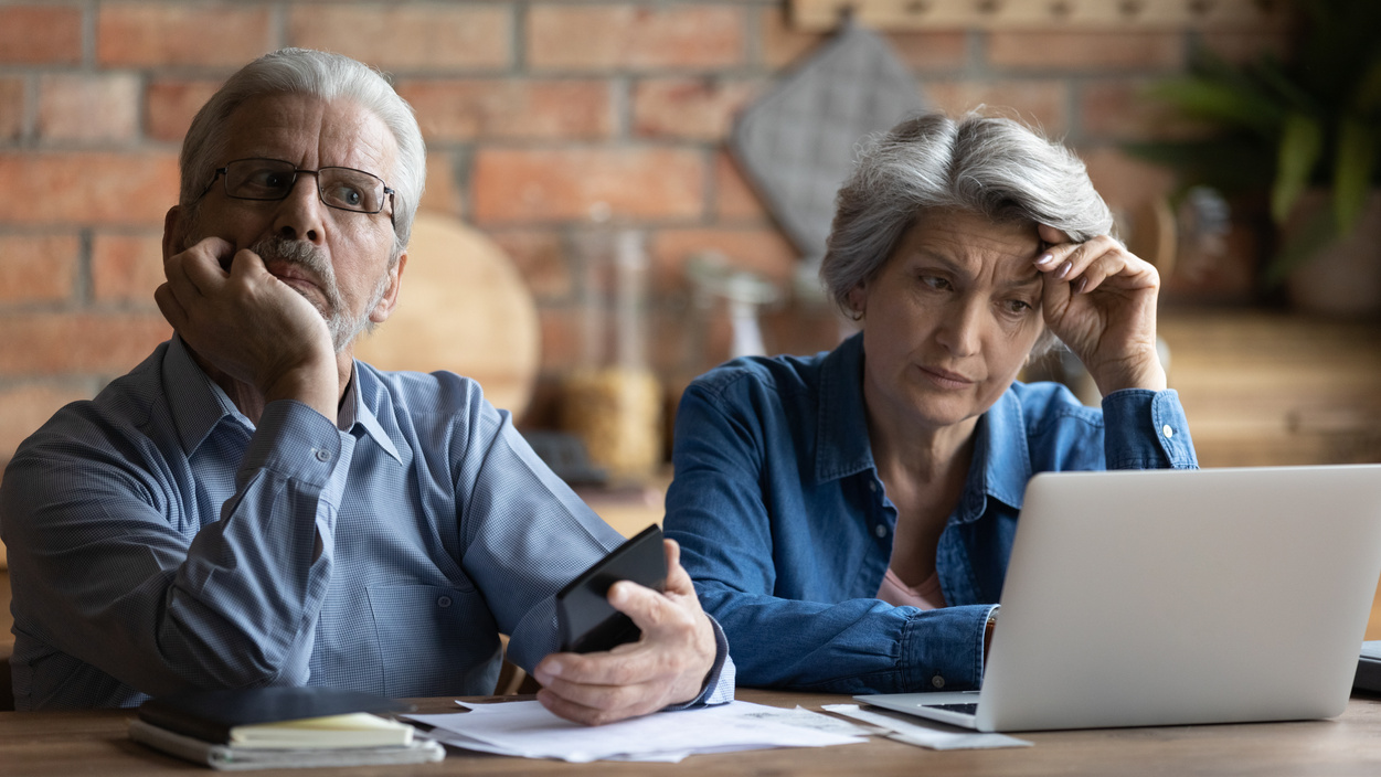 Unhappy older senior family couple thinking of financial problems.